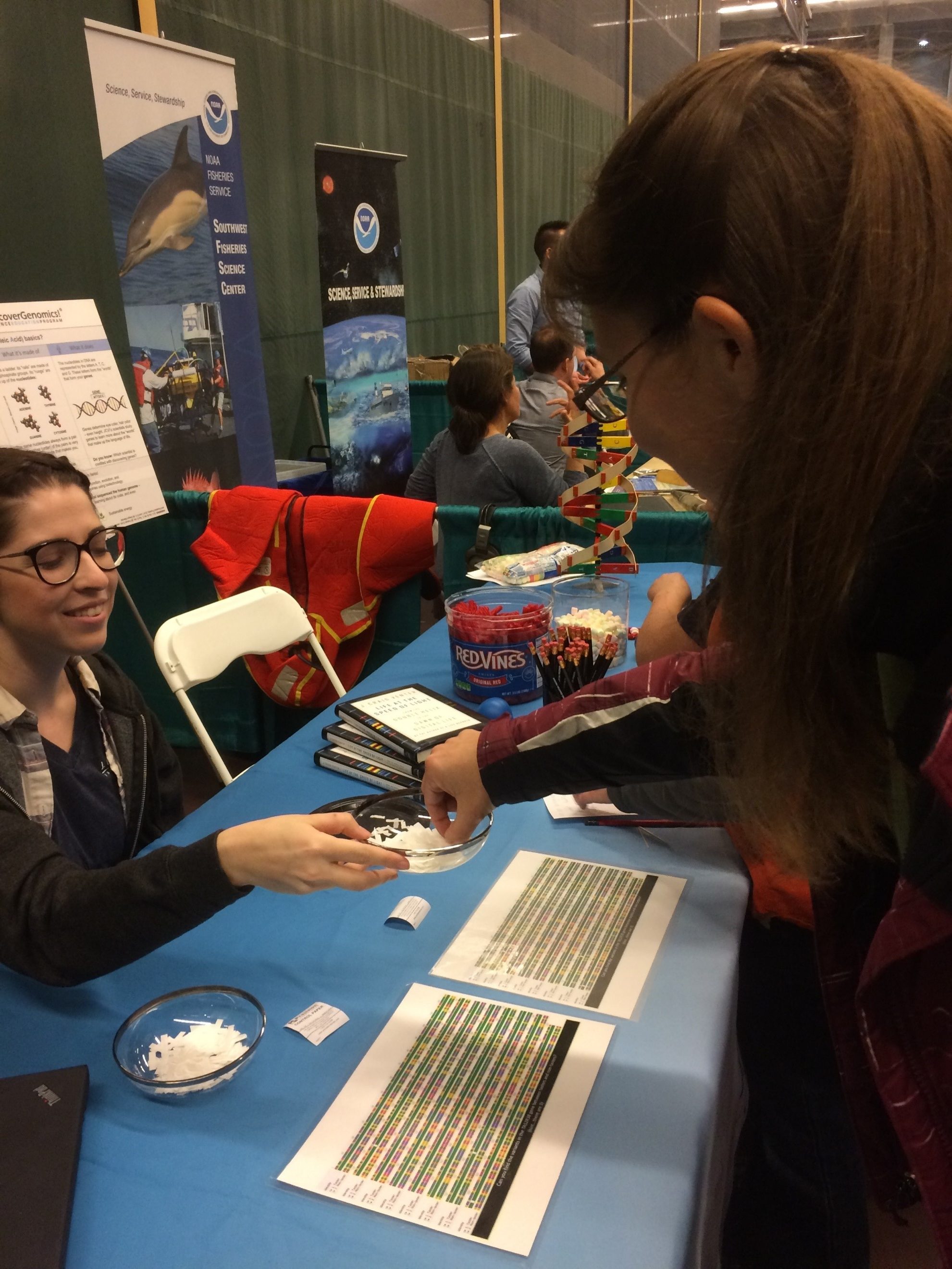 A student reaches in for a tasting strip to see if she can detect the bitter tastes of phenylthiocarbamide (PTC).