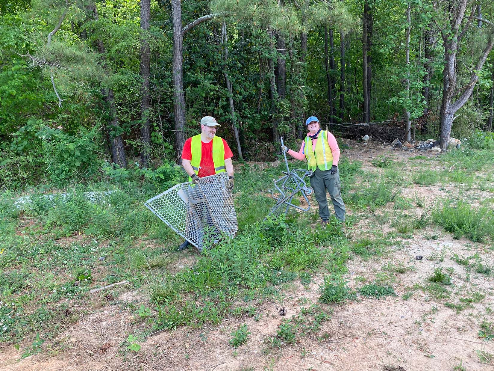 Shopping cart partially buried with silk flowers in the foreground